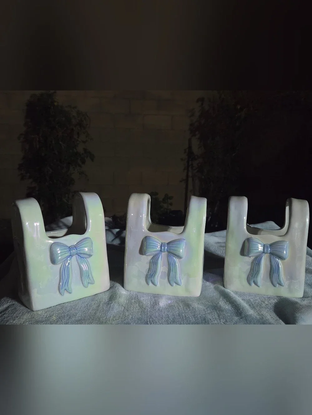 Iridescent ceramic purse vase. Spring 2025